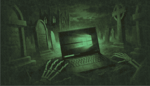 A dark and eerie nighttime graveyard scene featuring an outdated laptop with a faded Windows 10-style logo displayed on the laptop screen