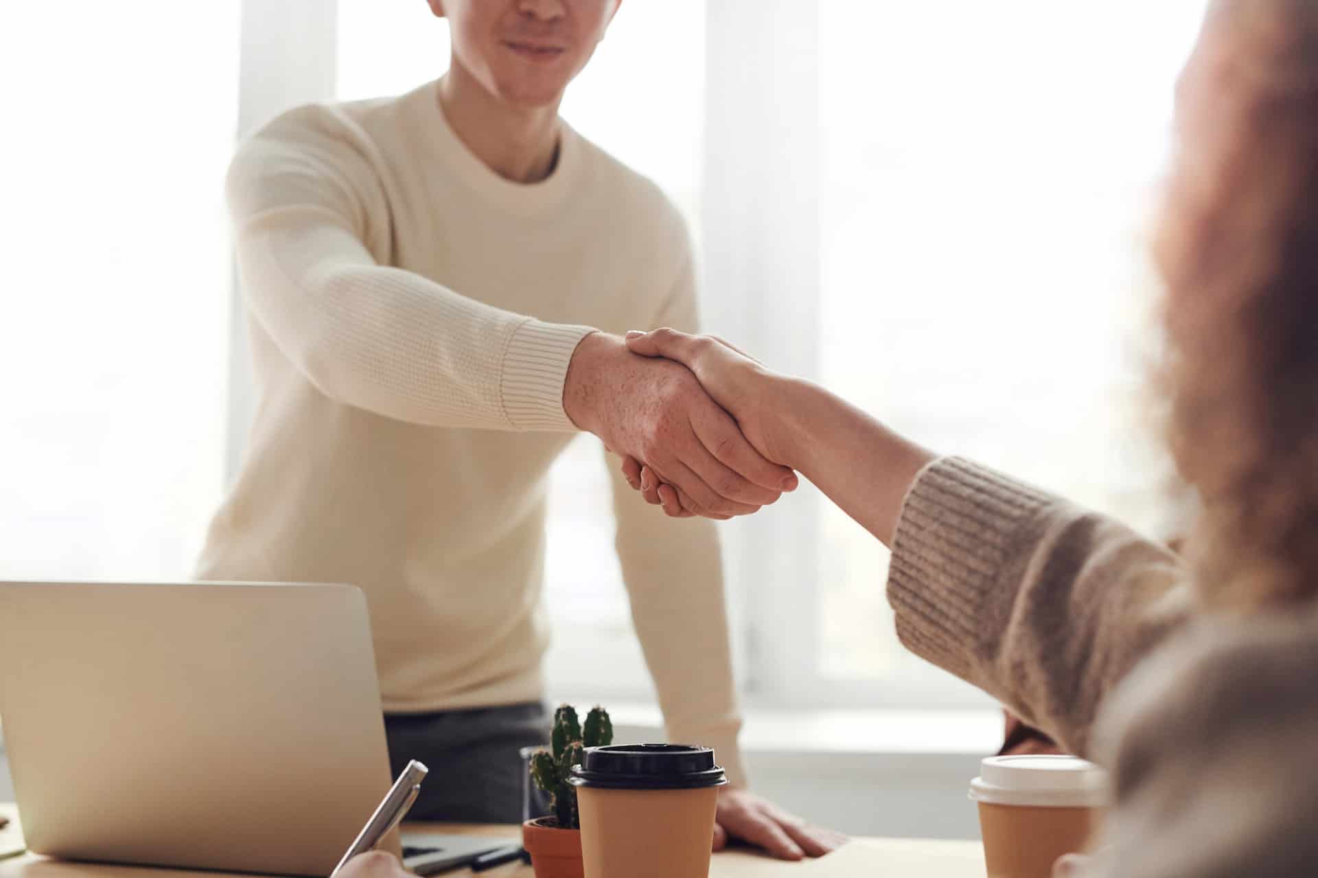 Man Woman Near Table Shaking Hands
