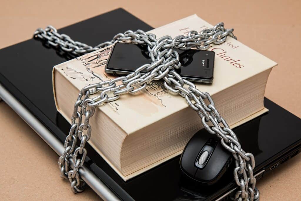 Black Android Smartphone on Top of White Book