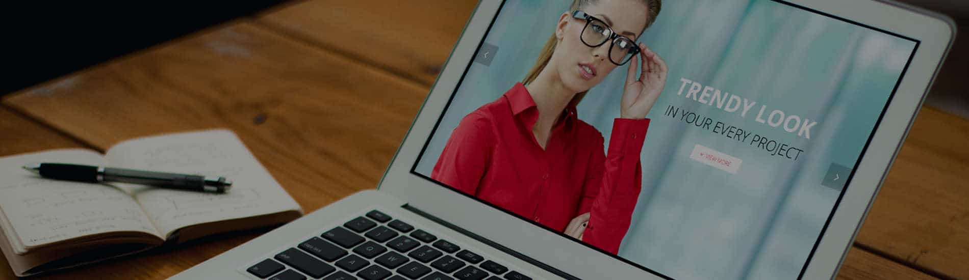 Laptop on table with woman on the laptop screen and message that says 'trendy look in every project'